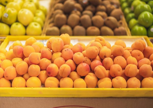 A vibrant display of organic apricots at a local market showcasing healthy produce.